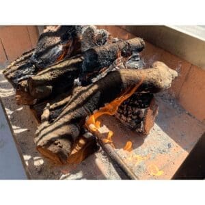 A log lighter can be added to a wood fired grill to make ignition faster.