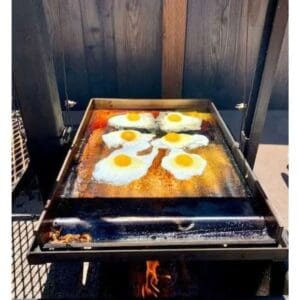 Cooking eggs and bacon on a plancha
