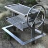 Argentinian Gaucho Grill Frame with V Grate Plates and Rod upper rack in stainless steel.