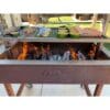 Cooking fish over an open fire on an Argentine grill