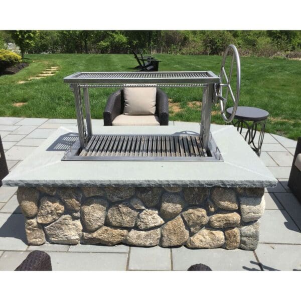 Stainless Argentine Style Campfire Gaucho grill in a firetable