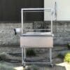 Stainless steel grill cart with rotisserie.
