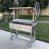 All stainless grill on casters for wood or charcoal.