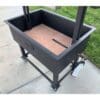 Brick lined firebox for durability and heat retention in a Santa Maria grill.