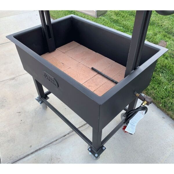 Brick lined firebox for durability and heat retention in a Santa Maria grill.