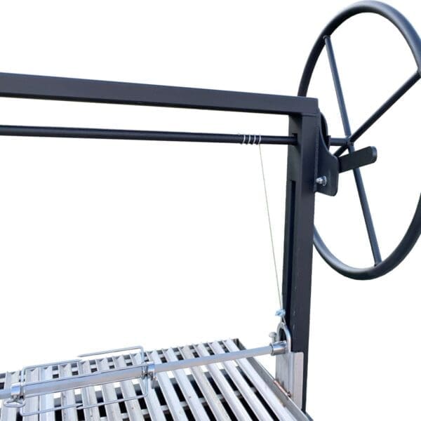 Large wheel for lifting a grate on a Santa Maria grill.