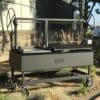 A commercial size grill for cooking outdoors with charcoal or wood.