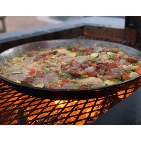 Cooking food on cast iron pan on an Argentine grill
