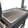 Rotisserie motor and forks on a height adjustable spit rod on an Argentine style grill with removable grates