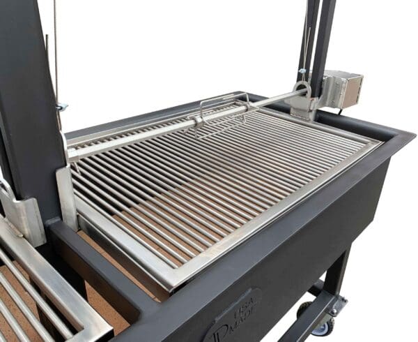 Rotisserie motor and forks on a height adjustable spit rod on an Argentine style grill with removable grates
