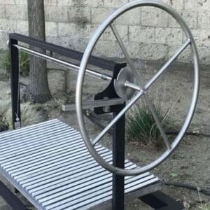 A stainless wheel for adjusting grate height on a charcoal or wood grill.
