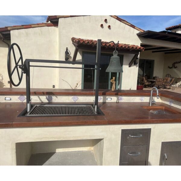 Custom Argentine Gaucho grill for a Spanish style outdoor kitchen