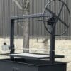 Single crank Santa Maria grill with large hand wheel.