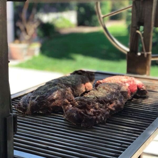 Wood grill with grill surface that moves up and down.