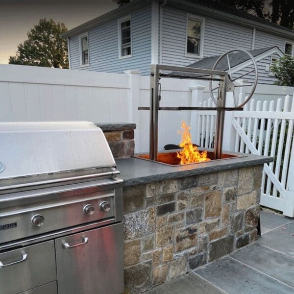 Stainless parrilla with adjustable grill grates for an outdoor kitchen.